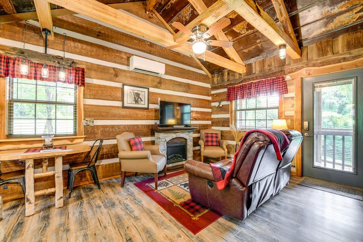 Cozy up in the log cabin living room's warm ambiance