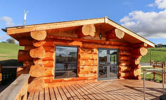 See the Inside of This Lakeside Cabin With a Huge Deck and Endless Meadows